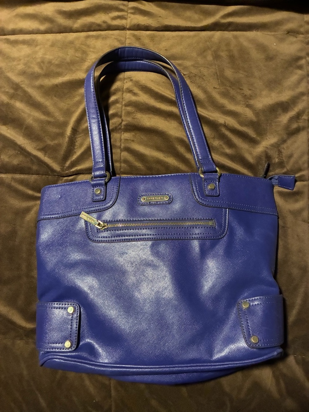 Anne Klein brand, blue purse with fun multicolor inside, small scratch on front